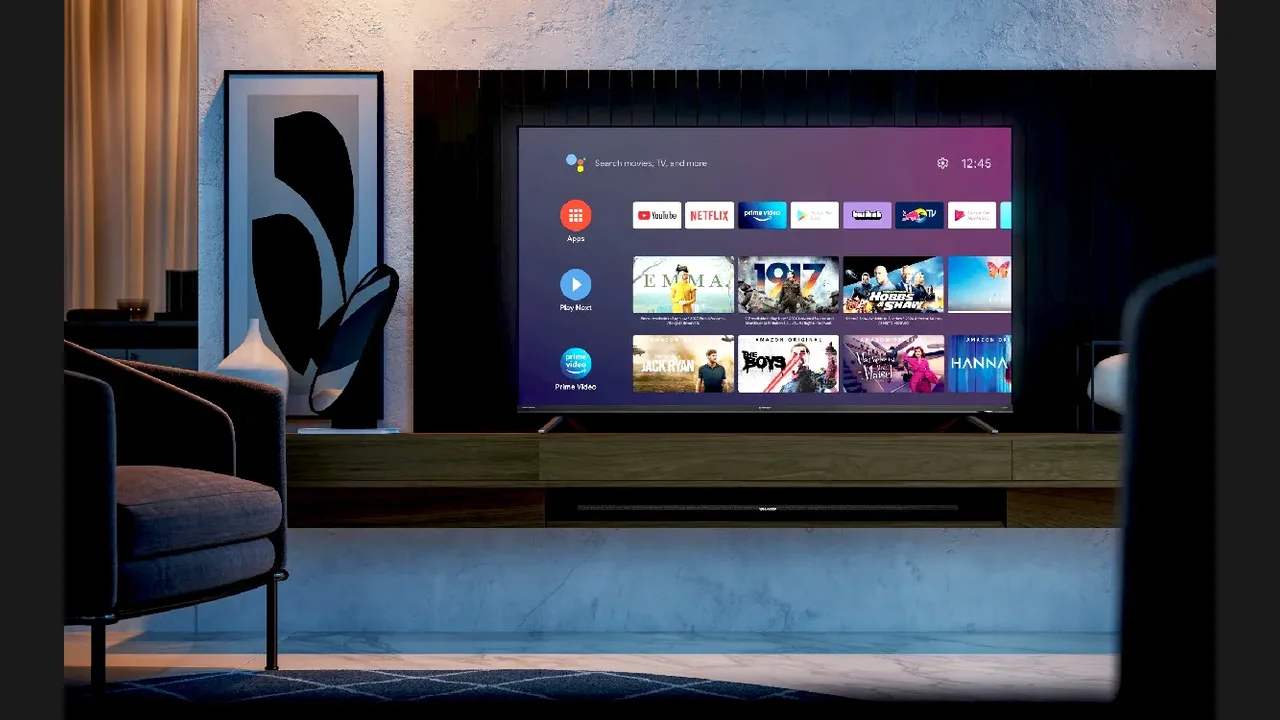 A large television showing streaming rows in a living room beside a sofa